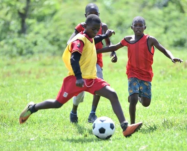 Boys playing football in the community