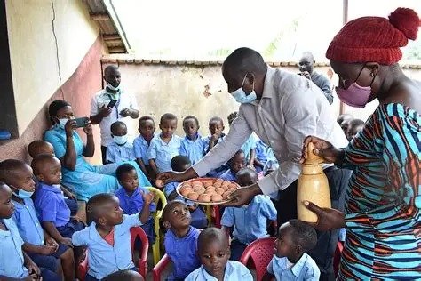 Staff serving food to school children
