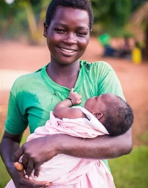 A young mother holding her newborn baby